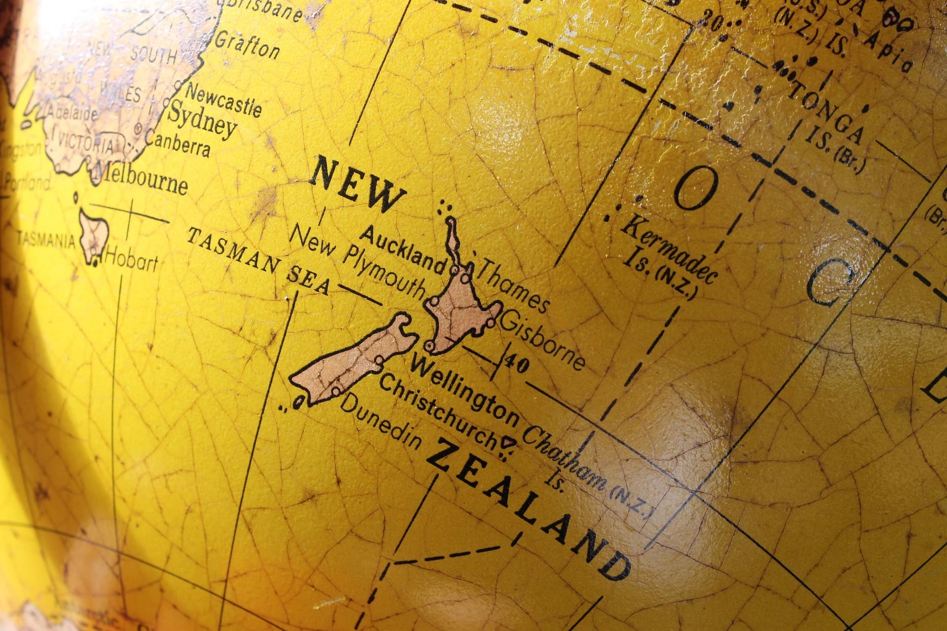 Vintage globe map focused on New Zealand